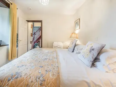 a bedroom with a large white bed with pillows at Berwyn Bank in Gilcrux