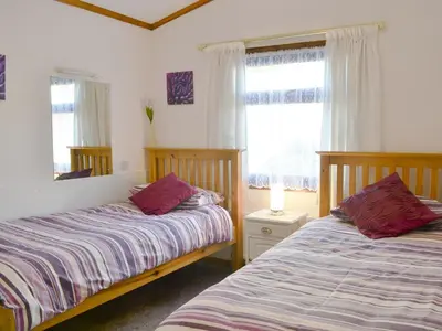 a bedroom with two beds and a window at Rosella in Bridekirk