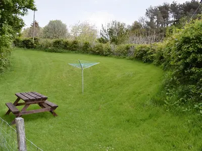 a picnic table and a net in a field at The Corn Mill in Branthwaite