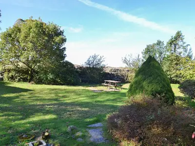 a park with a picnic table in the grass at Birkerthwaite Cottage-W41479 in Eskdale