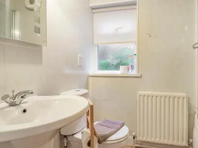 a bathroom with a sink and a toilet and a window at Galena in Glenridding