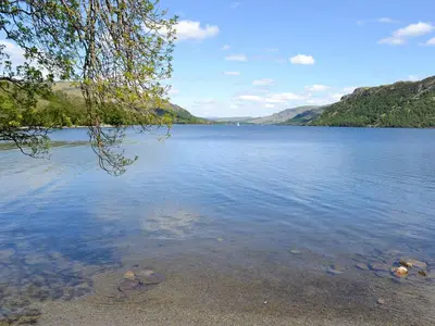 a view of a lake with mountains in the background at Stybarrow View Cottage in Glenridding
