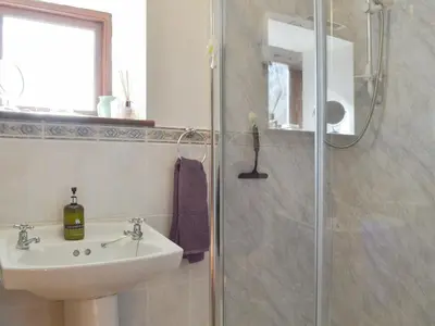 a bathroom with a sink and a shower at Stonefold Cottage in Waberthwaite