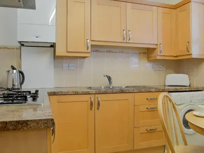 a kitchen with wooden cabinets and a sink at Inglewood - 15288 in Keswick