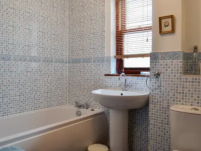 a bathroom with a sink and a bath tub and a sink at Inglewood - 15288 in Keswick