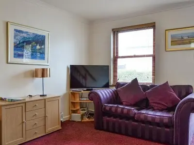 a living room with a couch and a flat screen tv at Glenwood - 18630 in Keswick