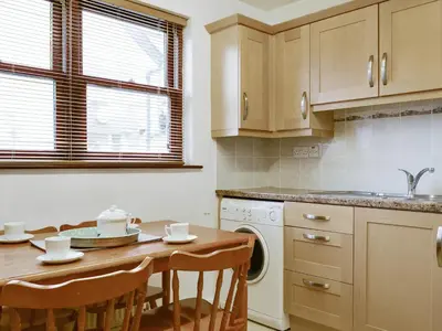 a kitchen with a table and a sink and a dishwasher at Glenwood - 18630 in Keswick