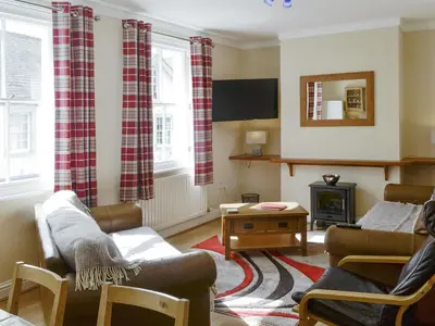 a living room with two couches and a fireplace at Skiddaw View in Keswick