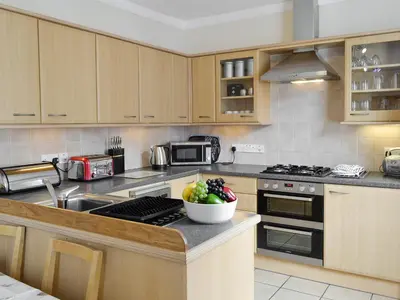 a kitchen with a bowl of fruit on the counter at Skiddaw View in Keswick