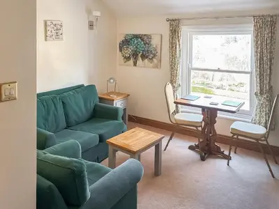 a living room with a couch and a table at Leatheswater in Thirlmere