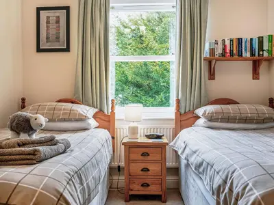 two twin beds in a bedroom with a window at Flat 4 in Keswick