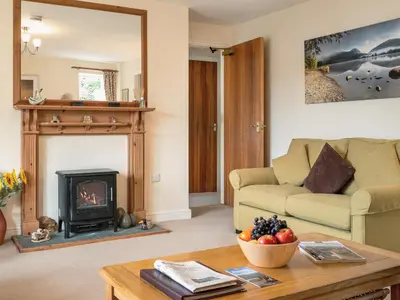 a living room with a couch and a fireplace at Flat 4 in Keswick