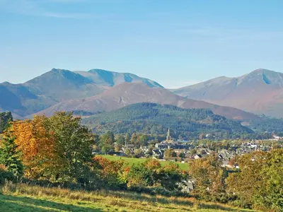 a town in a valley with mountains in the background at Little Beck in Troutbeck