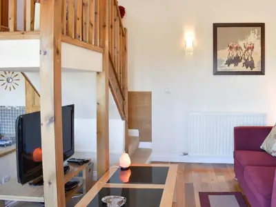 a living room with a couch and a tv at The Carriage House in Watermillock