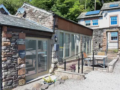 a stone building with a table in front of it at The Carriage House in Watermillock