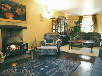 a living room with two chairs and a fireplace at Foldgate in Waberthwaite