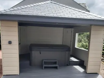 a large white shed with a bench in it at Oaklands in Langrigg