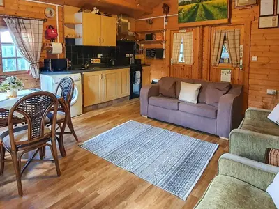 a living room with a couch and a table at Hedgehog Meadows in Waverton