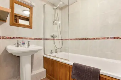 a bathroom with a sink and a shower and a tub at The Coppermines Mountain Cottages - Sawyers, Carpenters, Millrace, Sleeps 18 in Coniston
