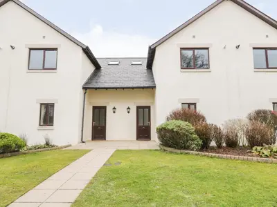 a white house with a black roof at Whitbarrow 24 in Penrith