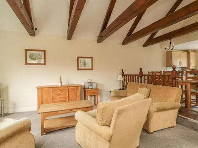 a living room with two chairs and a table at Whitbarrow 24 in Penrith