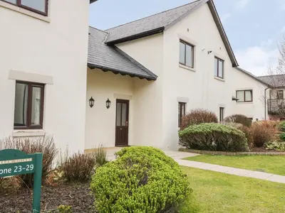 a white house with a sign in front of it at Whitbarrow 24 in Penrith