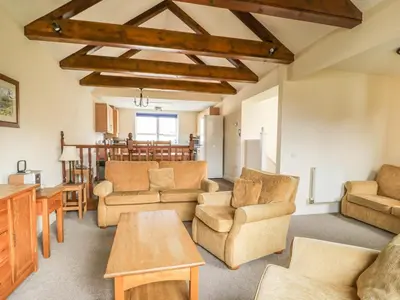 a living room with couches and chairs and a table at Whitbarrow 24 in Penrith