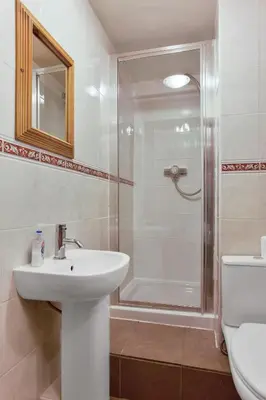 a bathroom with a sink and a shower at The Coppermines Mountain Cottages - Sawyers, Millrace, Pelton Wheel, Sleeps 16 in Coniston