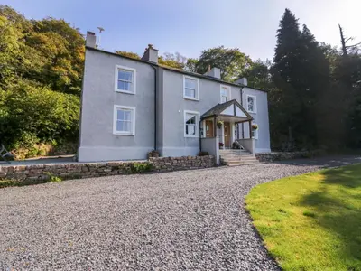 a large house with a gravel driveway at Dalegarth Hall Farm Cottage 2 in Holmrook