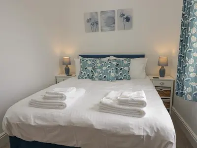 a bedroom with a bed with towels on it at Dalegarth Hall Farm Cottage 2 in Holmrook
