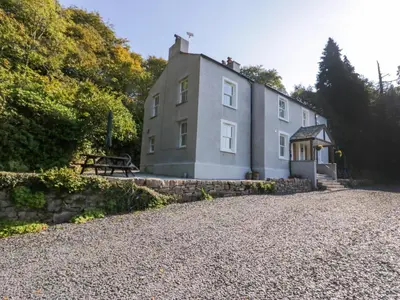 a large house with a gravel driveway at Dalegarth Hall Farm Cottage 2 in Holmrook