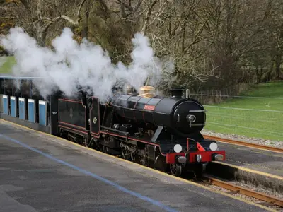a steam engine train is coming down the tracks at Dalegarth Hall Farm Cottage 2 in Holmrook