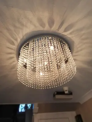 a large chandelier is hanging from a ceiling at Kirkcroft Guest House in Gretna