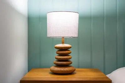 a zen rock tower sitting on a table with a lamp at The Queens in Carlisle