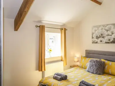 a bedroom with a bed and a window at The Granary in Wigton