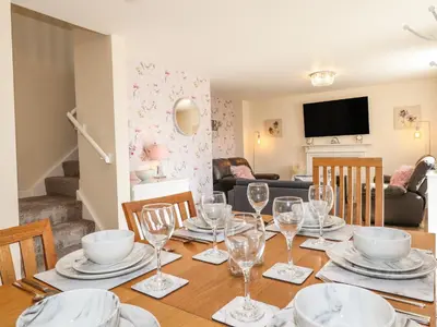 a dining room with a table with wine glasses at The Granary in Wigton