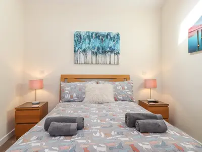 a bedroom with a large bed with two lamps at The Granary in Wigton