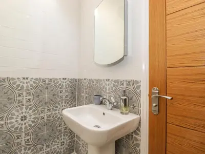 a bathroom with a sink and a mirror at The Granary in Wigton