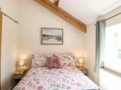 a bedroom with a bed and two night stands at The Granary in Wigton