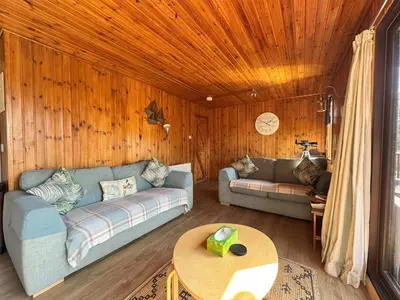a living room with a couch and a table at The Vital Spark in Gatehouse of Fleet