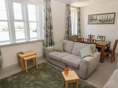 a living room with a couch and a table at Rose Bank Cottage in Carlisle