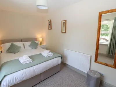 a bedroom with a bed with towels on it at Rose Bank Cottage in Carlisle