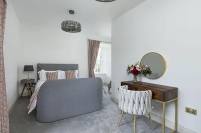 a bedroom with a bed and a mirror at East Wing in Thornhill