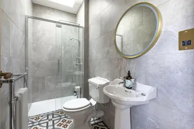 a bathroom with a toilet and a sink and a shower at East Wing in Thornhill
