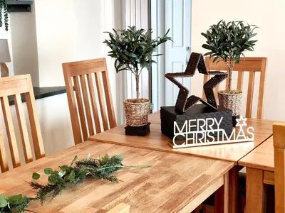 a wooden table with a merry christmas sign on it at The Paddock in Keswick