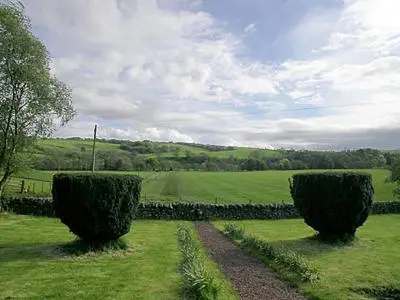 two bushes in the middle of a green field at Kilpatrick Farm House in Pinmore