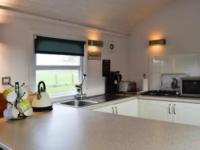 a kitchen with a sink and a counter top at The Carriage in Bridge of Dee