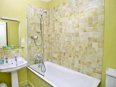a bathroom with a tub and a sink and a shower at Marwhin House - Swwr in Kirkpatrick Durham