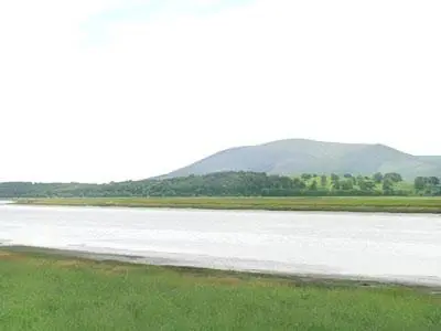a large body of water with mountains in the background at Martha's Shore Cottage in Glencaple