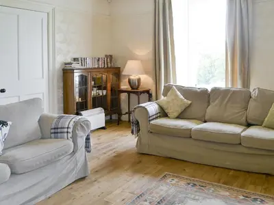 a living room with two couches and a window at Burnfoot Of Cluden in Holywood